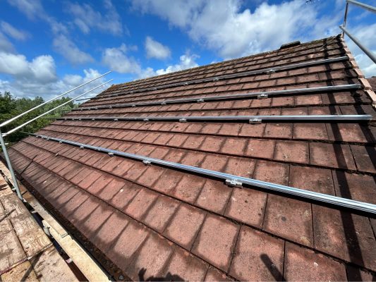 Solar panel mounting rails fixed to a tiled roof ready for the 6.65kWp Aiko array